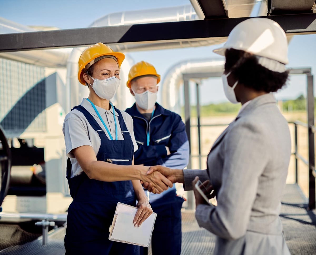 Workers reviewing safety records together on site