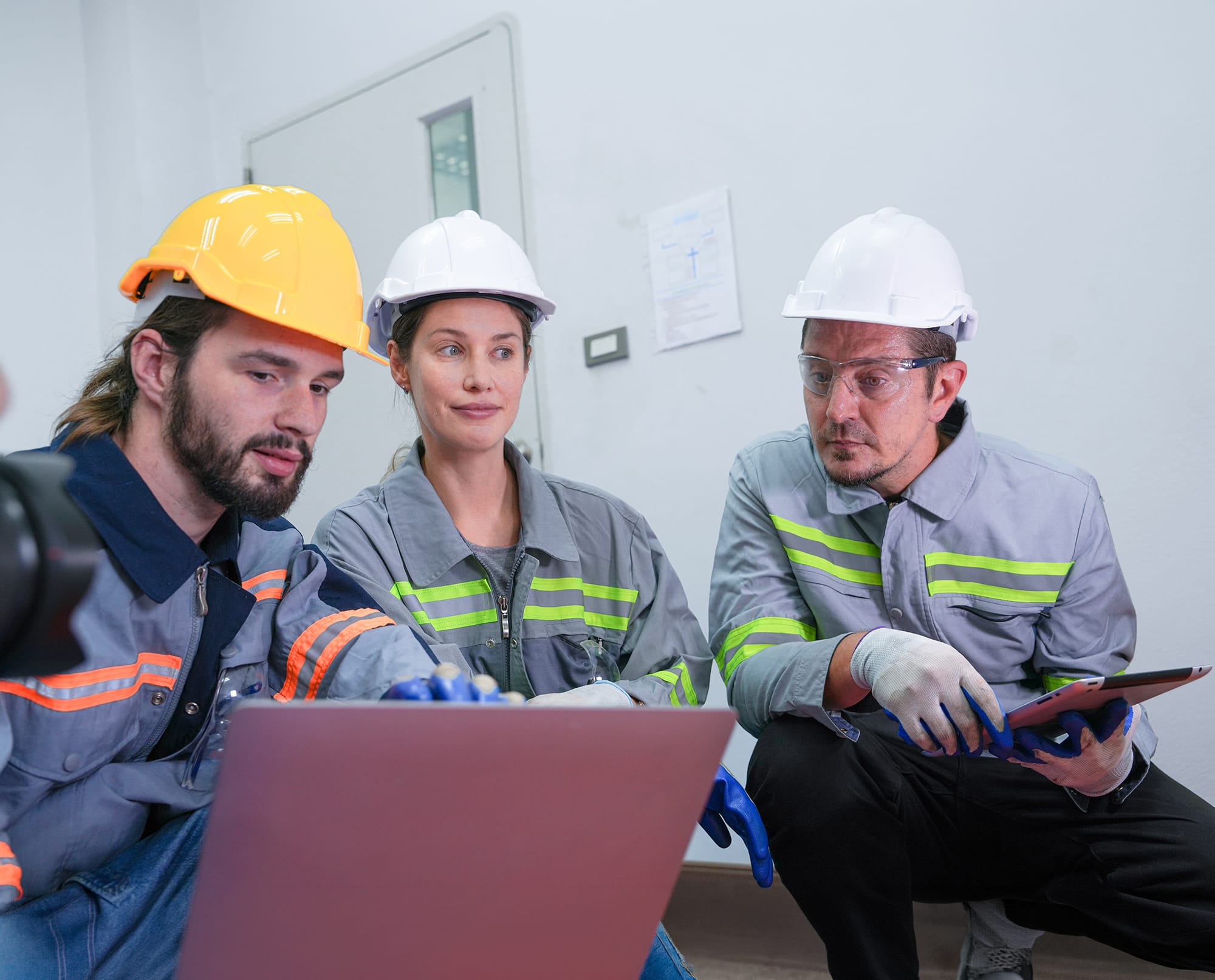 Workers reviewing safety records together on site